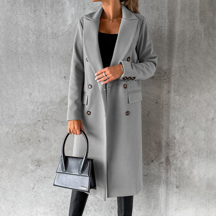 Woman posing in a sophisticated grey winter coat