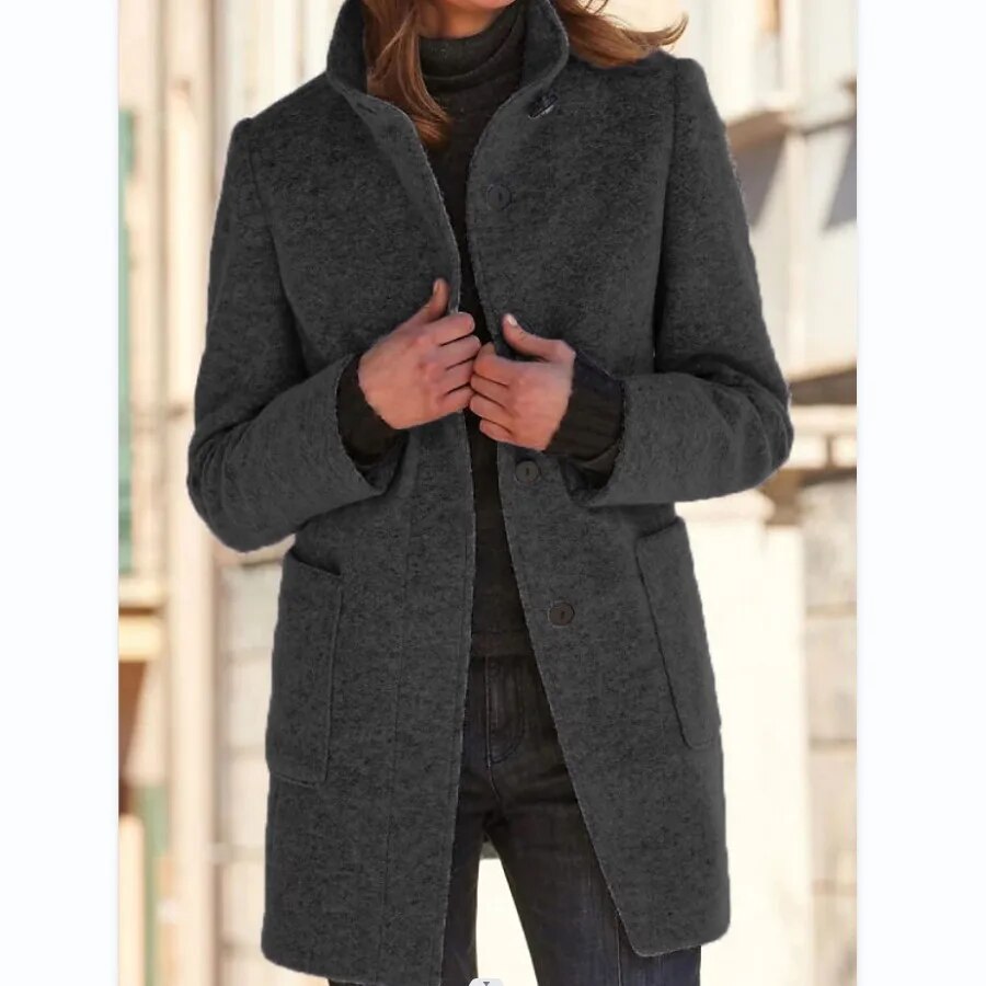 Close-up of warm winter coat fabric texture and button detail