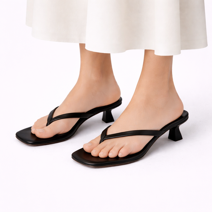 Women wearing black summer heeled orthopedic slippers with thong strap
