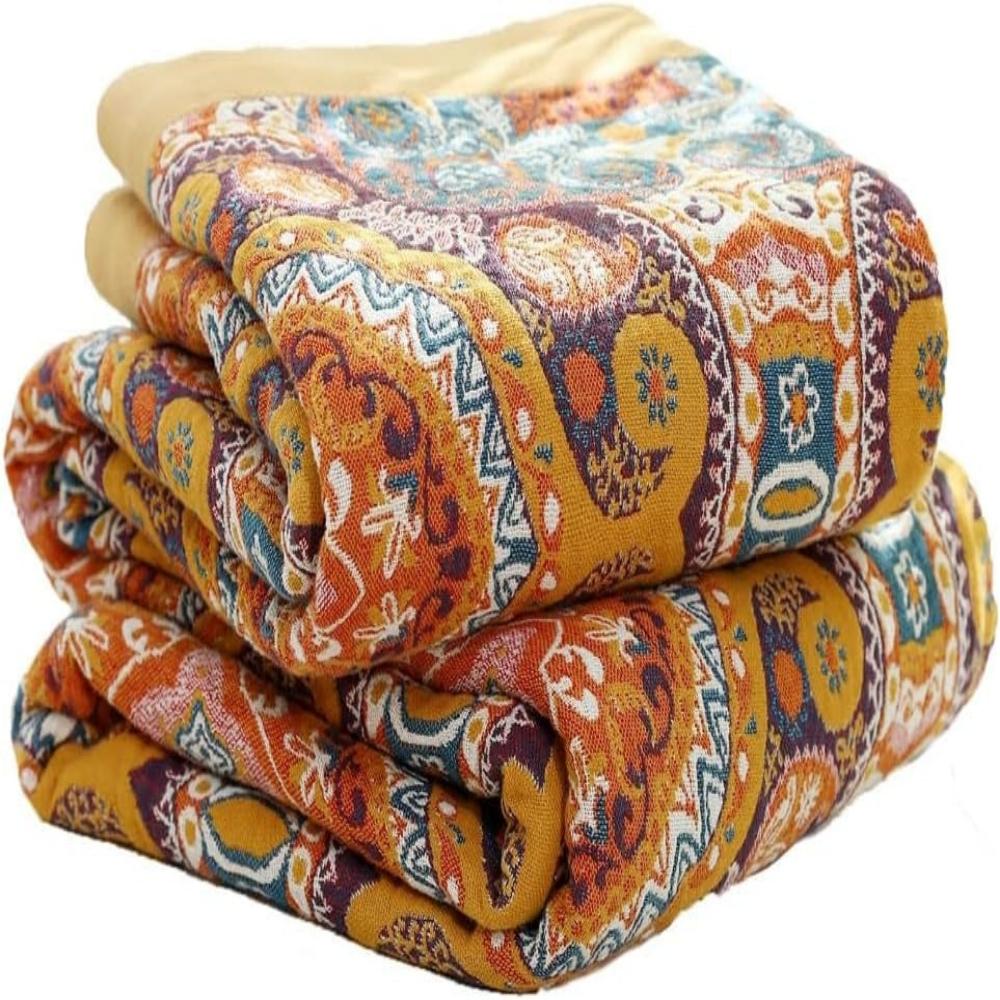 Folded boho reversible cooling blanket showing vibrant patterned fabric and soft yellow border