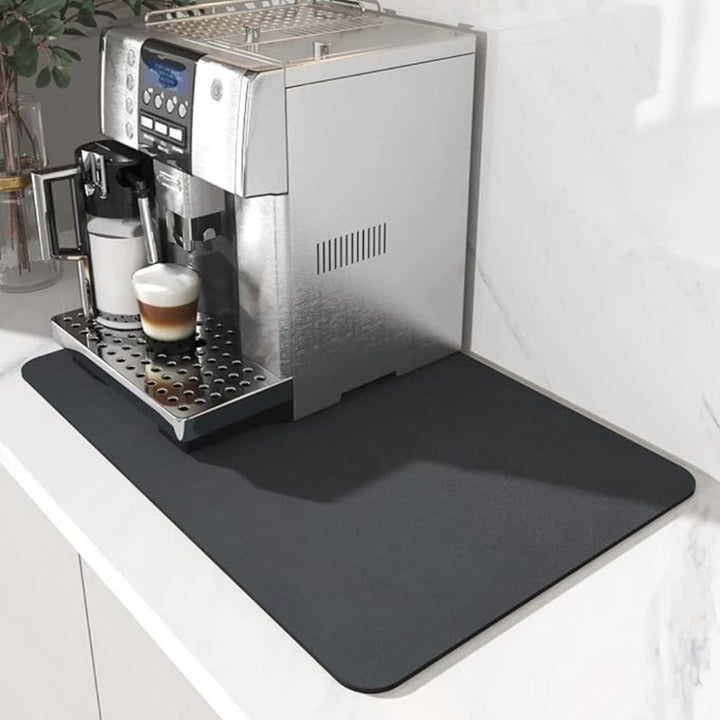 Dark gray coffee bar mat protecting a kitchen counter beneath a coffee maker