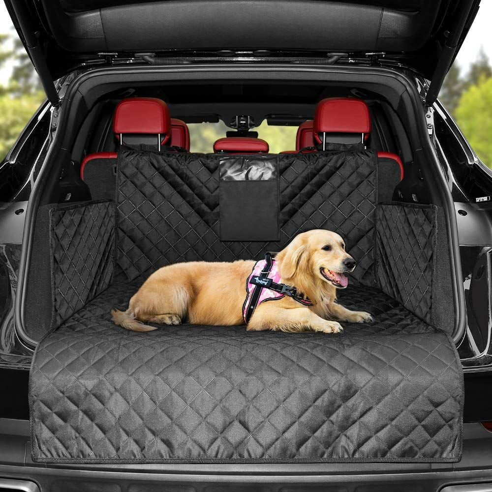 Golden retriever resting comfortably on a black waterproof SUV trunk cover