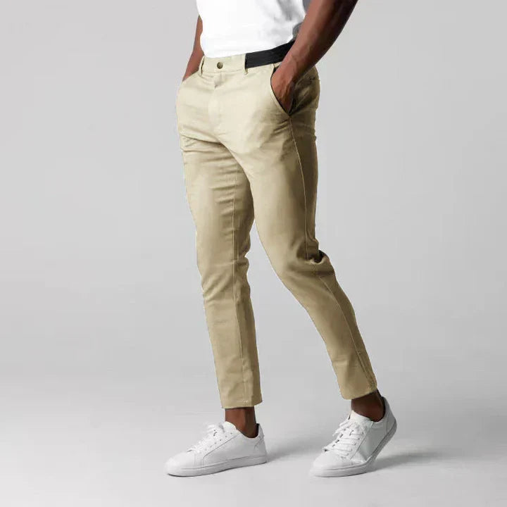 Man wearing Sylvester men's slim fit khaki chino pants with white sneakers