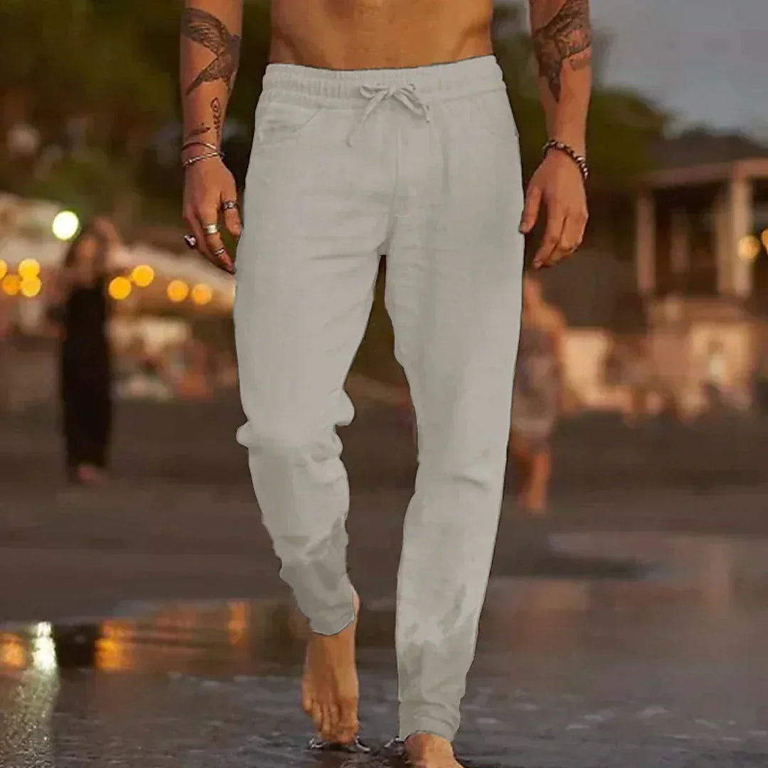 Man wearing light grey trousers outdoors in the evening