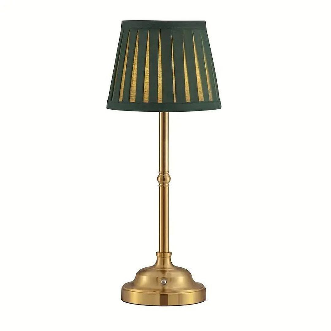 Green table lamp with pleated tapered shade and gold base on white background