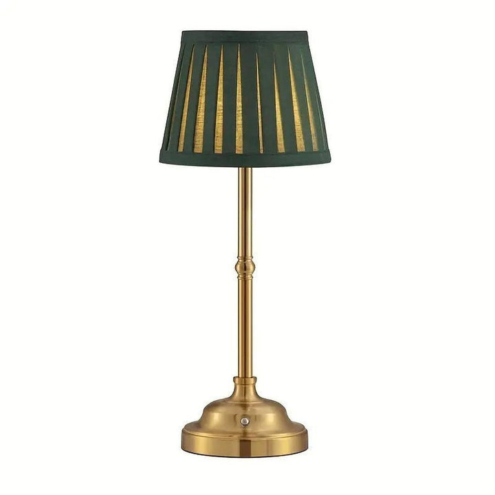 Green table lamp with pleated tapered shade and gold base on white background