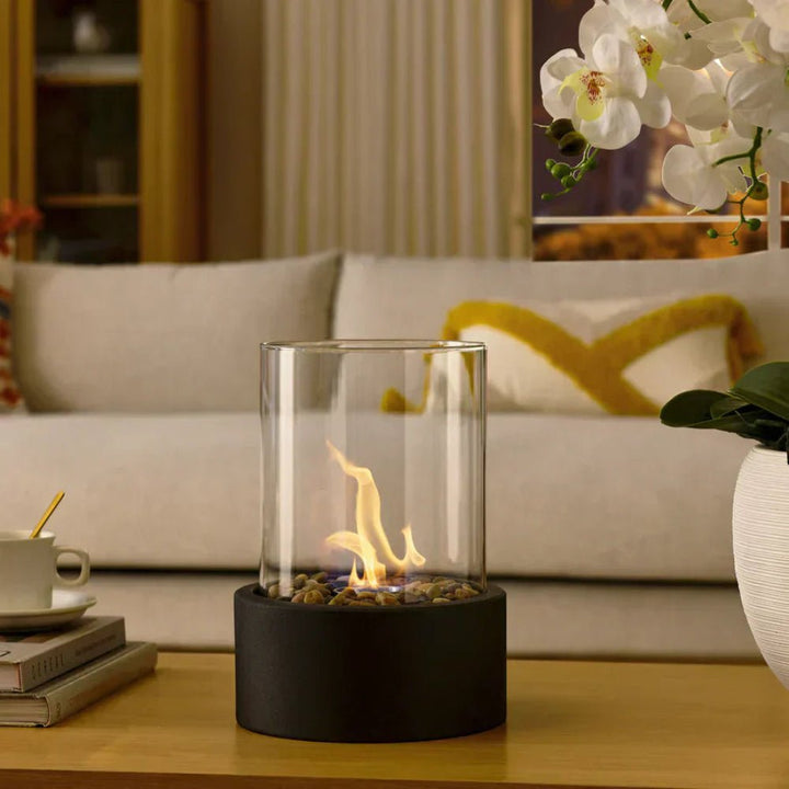 Close-up of glass fire bowl and burner creating cozy living room lighting