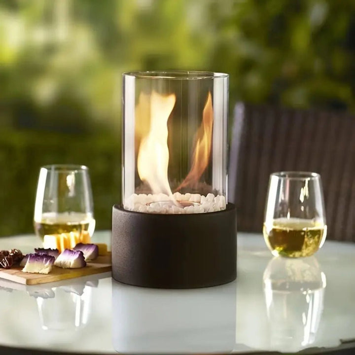 Elegant tabletop fireplace with clean glass panels lit up for ambient lighting