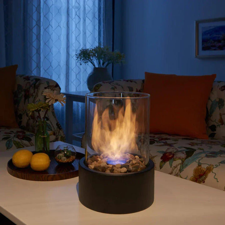 Portable glass tabletop fireplace showing realistic bioethanol flame for indoor ambiance