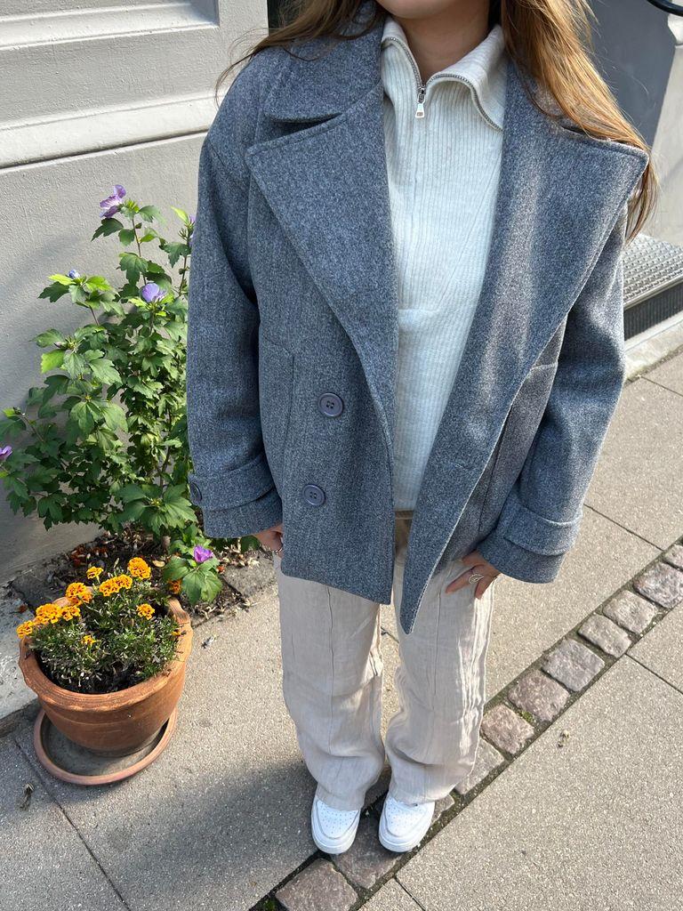 Side profile of the women's tailored winter coat showing sleek silhouette