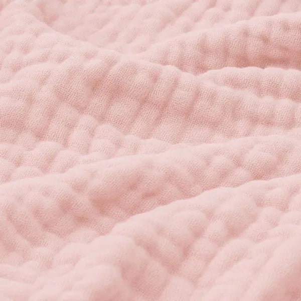 Detailed shot of textured muslin weave emphasizing softness and quality