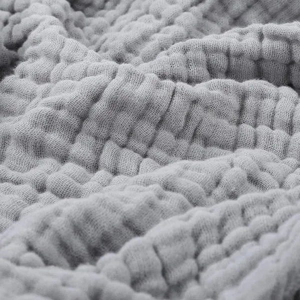 Rolled cozy living throw blanket tied with twine, ideal for gifting
