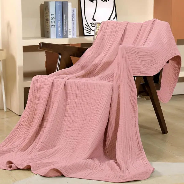 Folded soft muslin throw blanket showcasing lightweight texture for cozy living