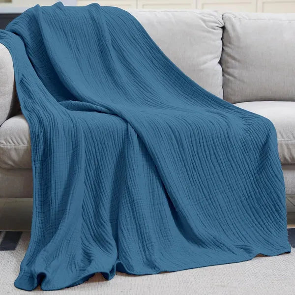 Close-up view of breathable muslin blanket fabric and delicate hem stitching