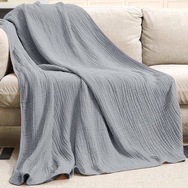 Cozy sofa blanket draped over a living room couch for stylish home decor