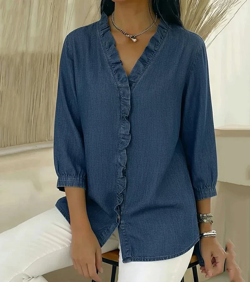 Front view of a woman wearing the stylish button-down ruffle blouse