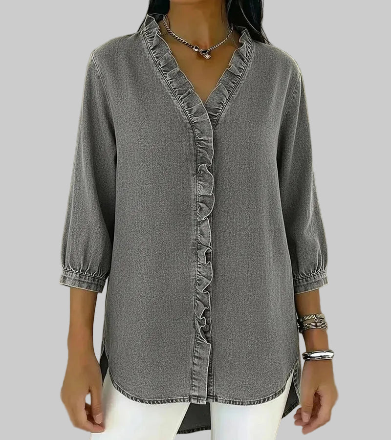 Close-up of the fabric and button details on the chic ruffle top