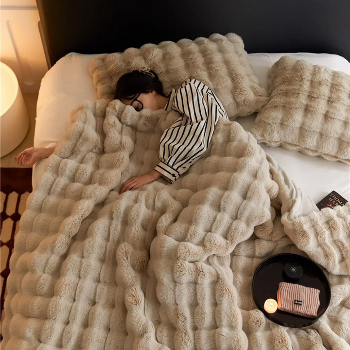 Cozy plush fleece blanket folded neatly, showcasing ultra-soft texture for bed and sofa.
