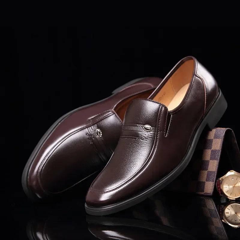 Men's brown orthopedic slip-on dress loafers displayed on a dark surface