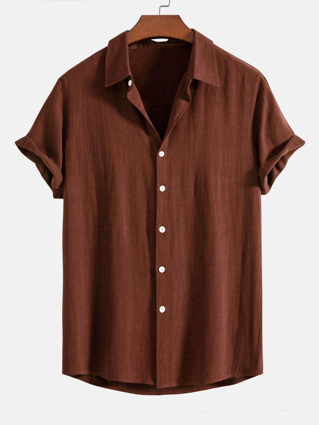 Brown short sleeve button-down shirt hanging on a wooden hanger