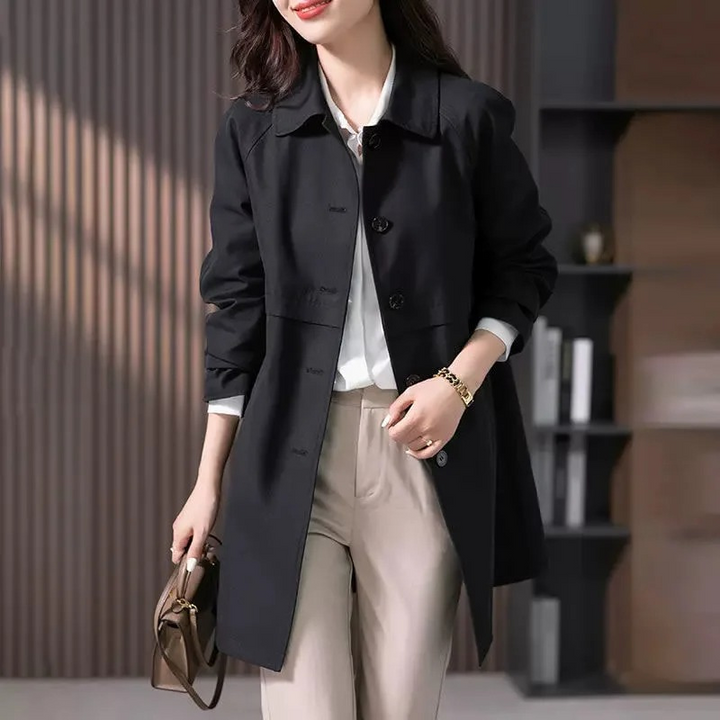 Classic dark blue button-front mid-length trench coat for women, stylish outerwear fashion.