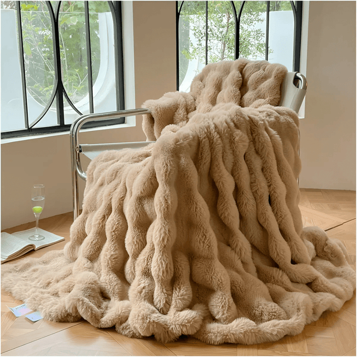 Light brown thermal fleece throw blanket elegantly displayed on a contemporary chair