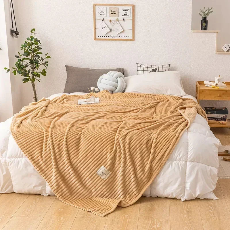 Plush bedding blanket in neutral tone spread flat to display full size and softness