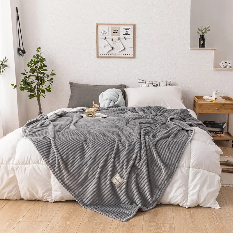 Cozy flannel throw blanket draped over a modern sofa for stylish home decor