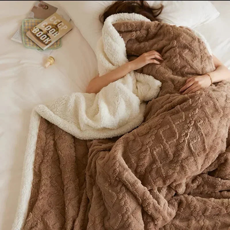 Person resting comfortably under a thick brown winter blanket on a bed