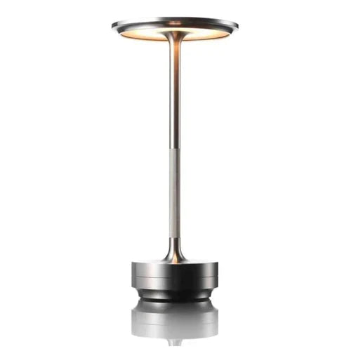 Portable touch control table lamp illuminating a modern desk setup