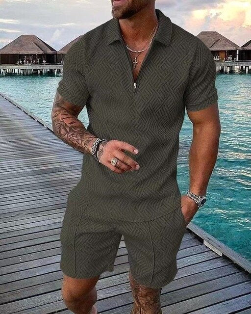 Man wearing a green polo and shorts coordinated summer set by the water