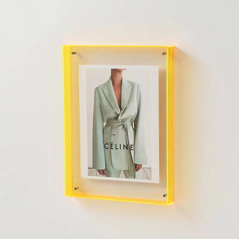 Close-up view of clear floating photo frame showing magnetic closure and pins