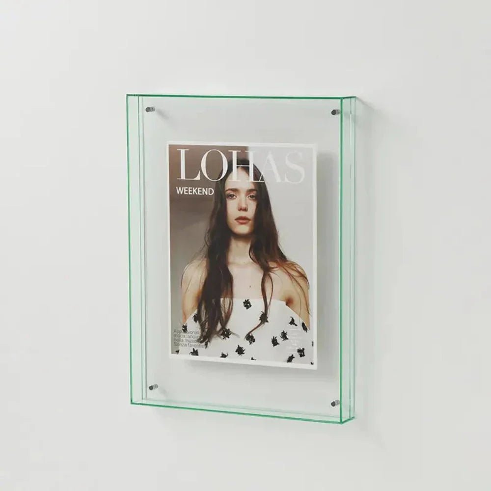 Minimalist transparent frame holding art print, styled on a modern bookshelf