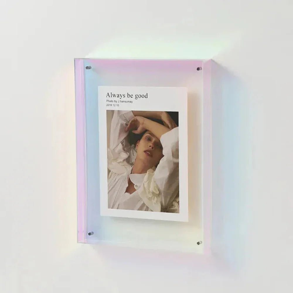 Transparent acrylic floating photo frame displaying a nature print on a wooden desk
