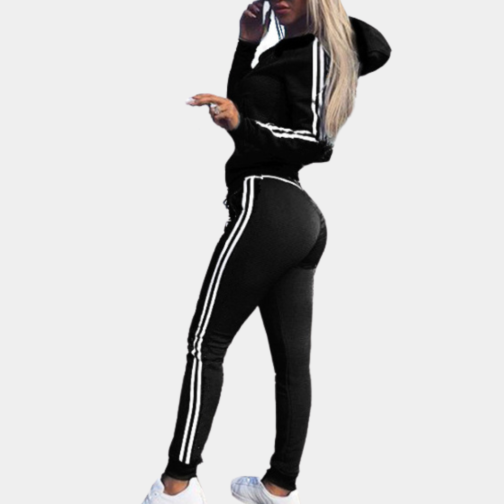 Woman wearing a black two-piece tracksuit with matching trousers and hoodie