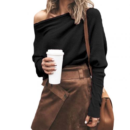 Woman wearing a black off-shoulder sweater with a brown skirt