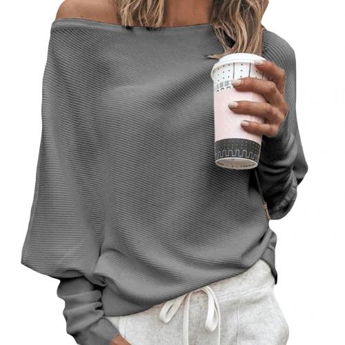 Close-up of a woman in a grey off-shoulder sweater