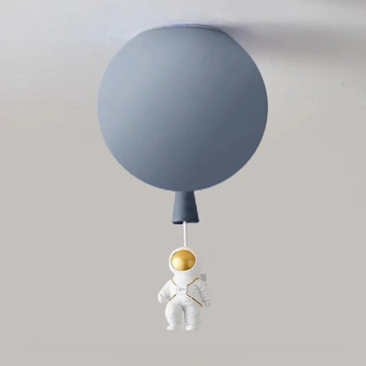 Whimsical moon and astronaut kids light fixture turned on