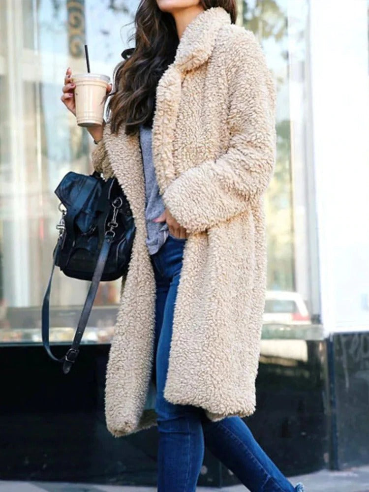 Side view of a woman in an apricot fluffy long coat walking in the city