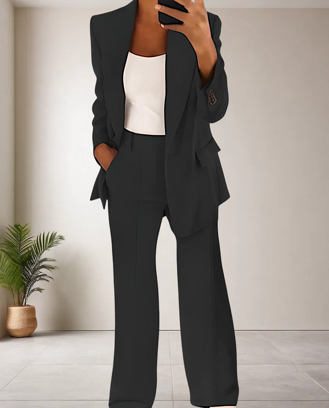 Woman wearing the classic black two-piece pantsuit set