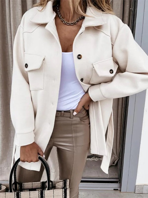 Woman wearing a beige button-down windbreaker jacket with utility pockets