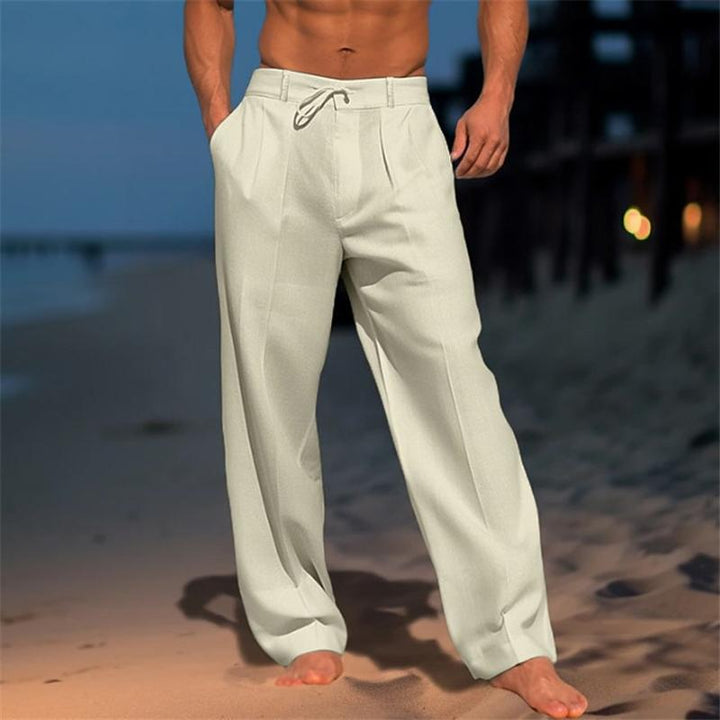 Man wearing khaki wide leg pleated trousers outdoors