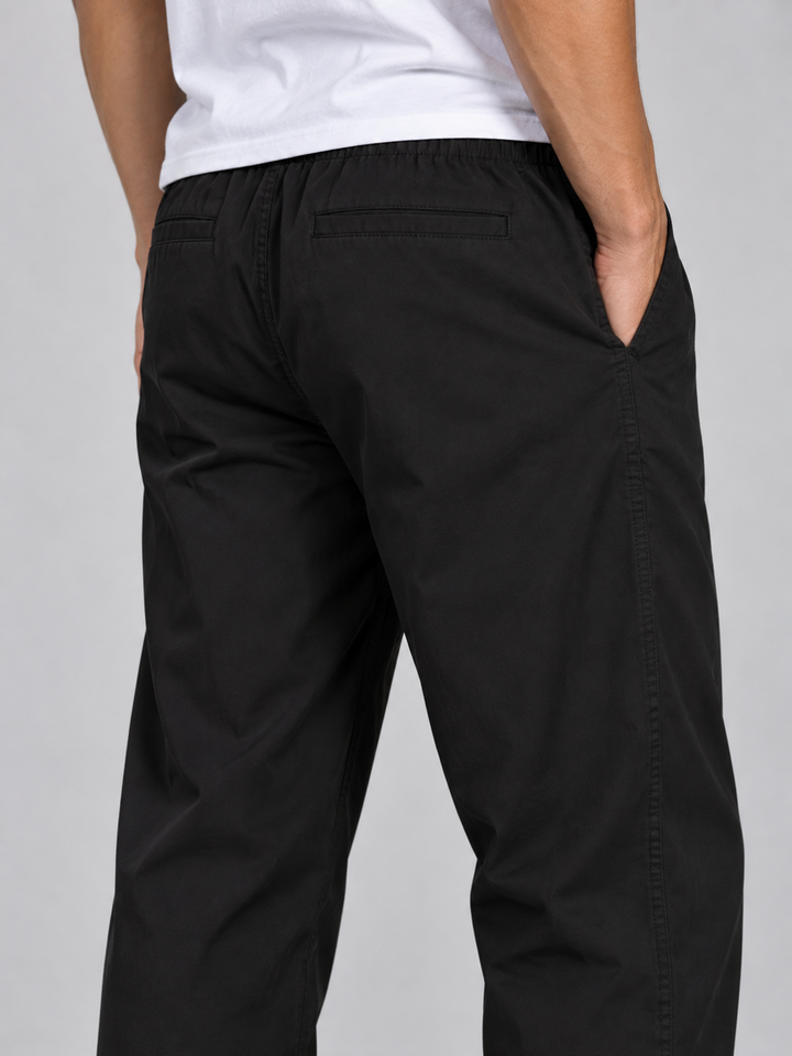 Back view of casual men's outdoor trousers showcasing breathable lightweight material