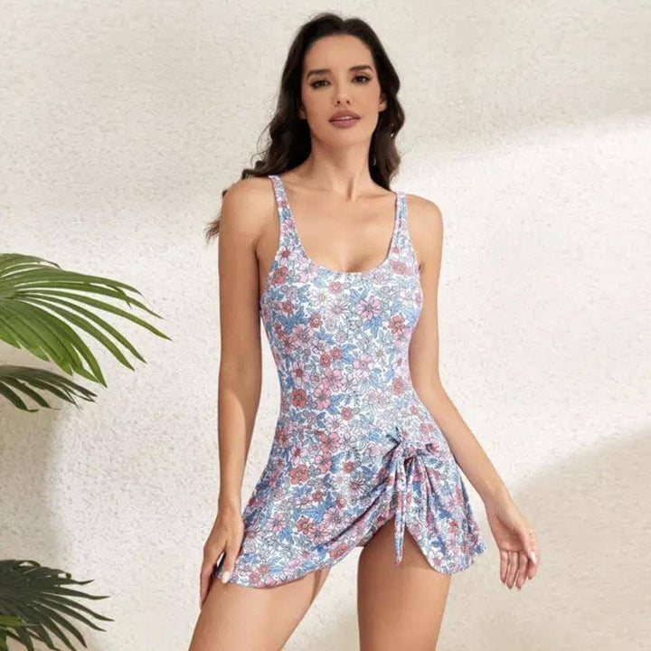 Model wearing blue floral print one-piece swimsuit