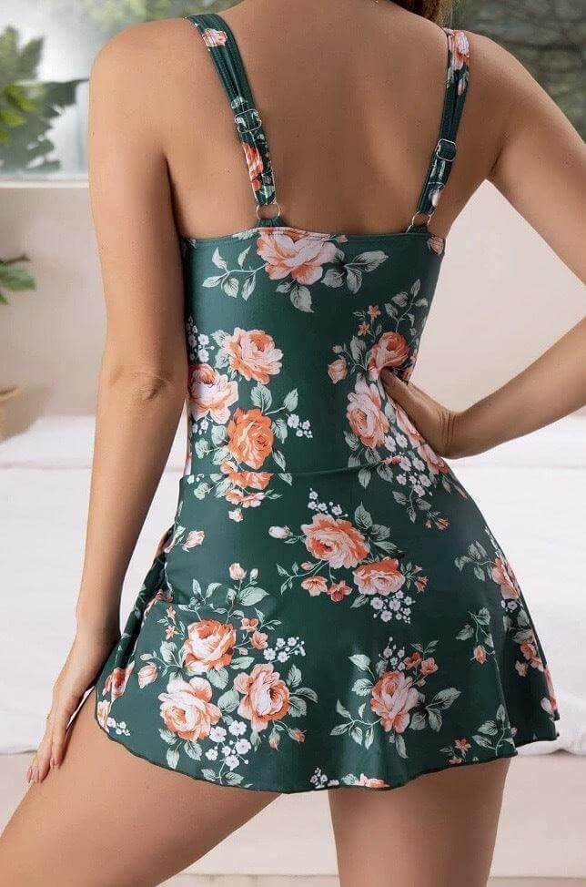 Flat lay of the stylish tummy control swim dress ready for a beach vacation