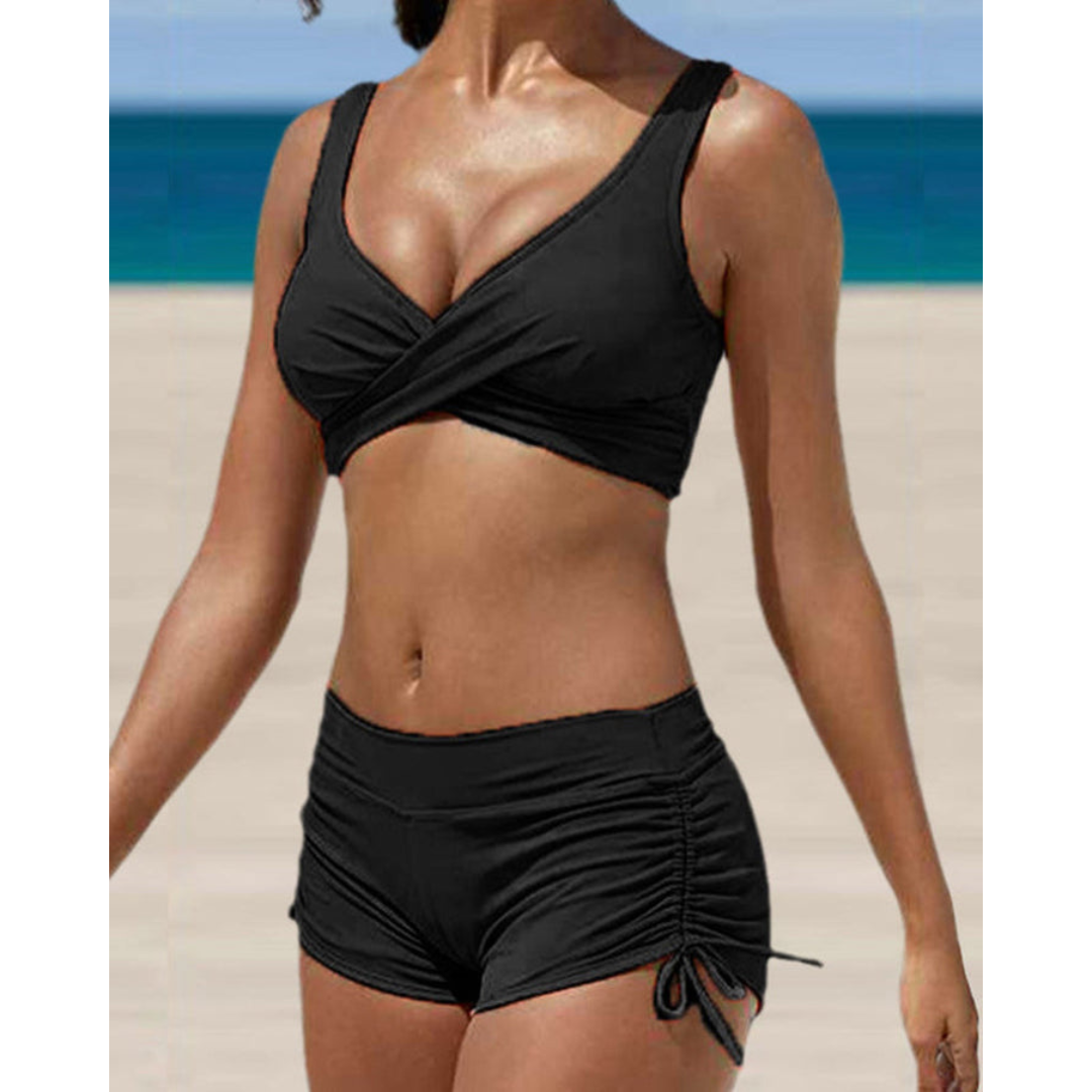 Woman wearing a black two-piece shaping bikini with high waist