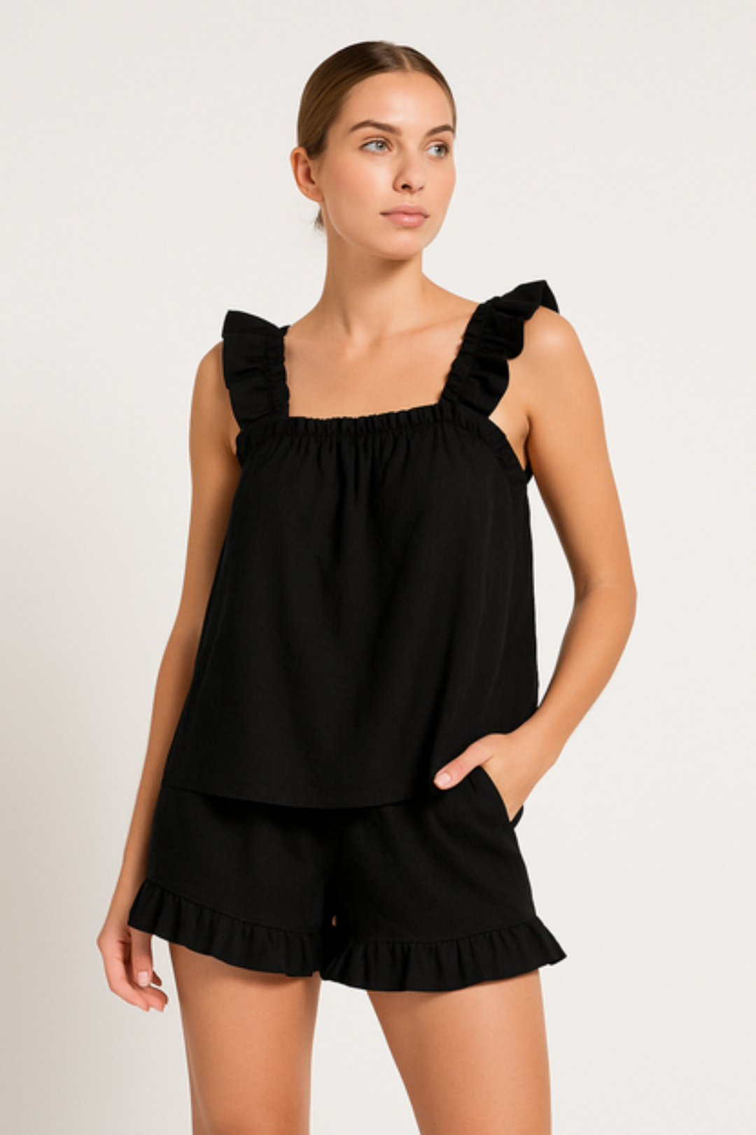 Woman wearing the black summer ruffle pyjama set
