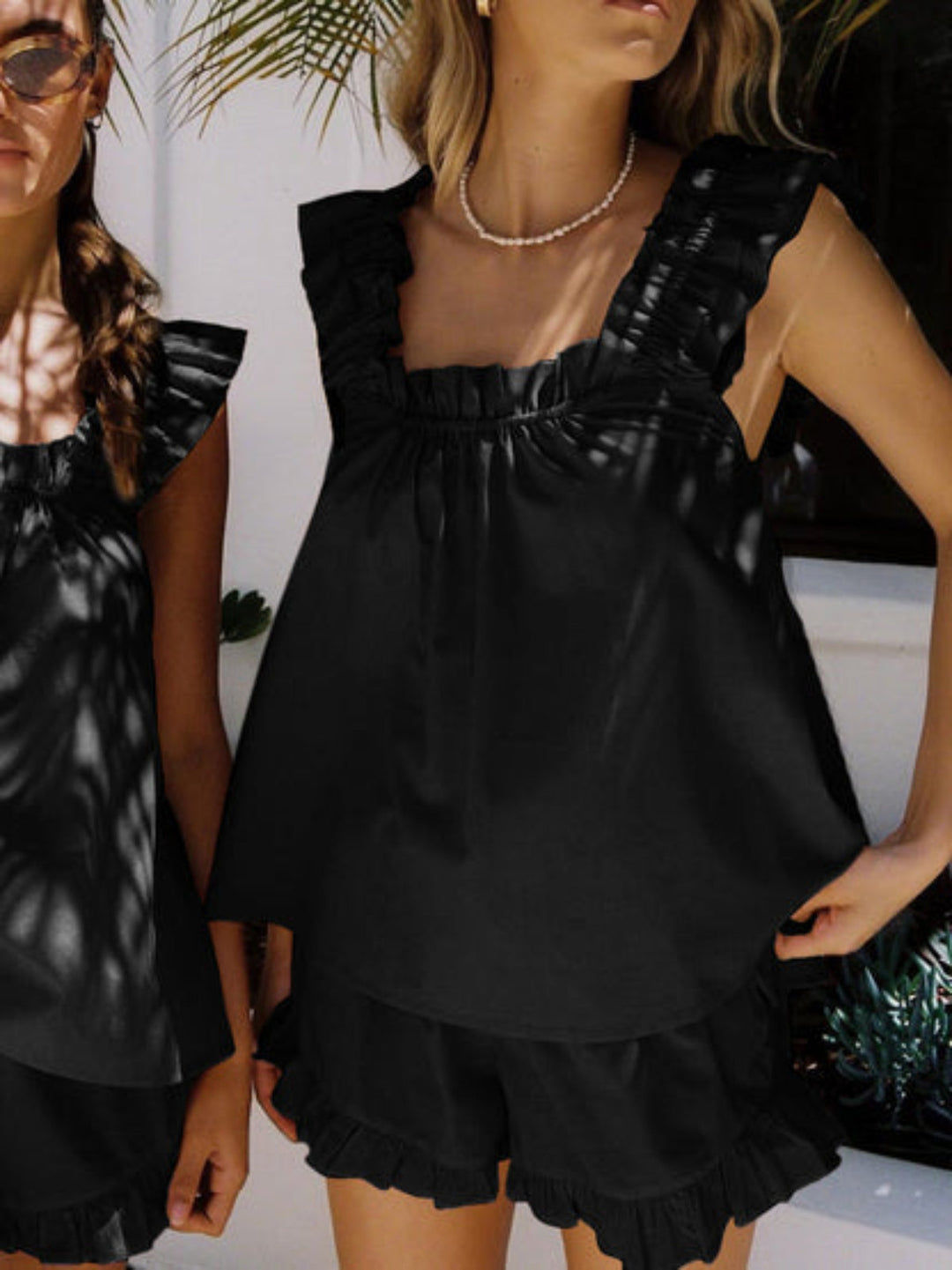 Womens summer ruffle pyjama set featuring a sleeveless top and matching shorts in lightweight fabric.