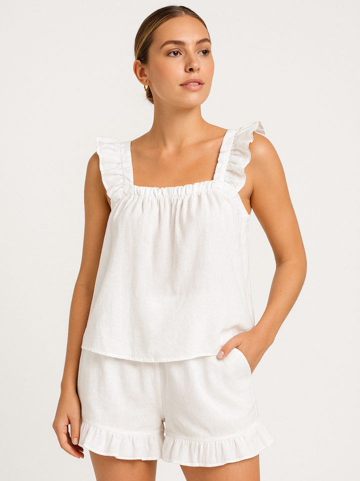 Woman wearing the white summer ruffle pyjama set