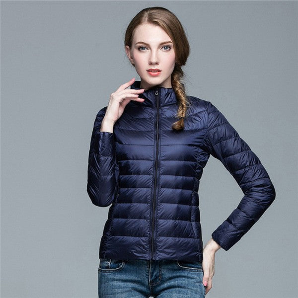 Model wearing navy blue lightweight urban chic women down jacket with front zipper